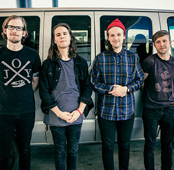 Band on tour in front of van